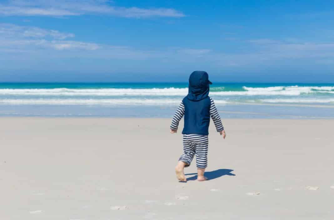 Bébé portant une combinaison UV à la plage