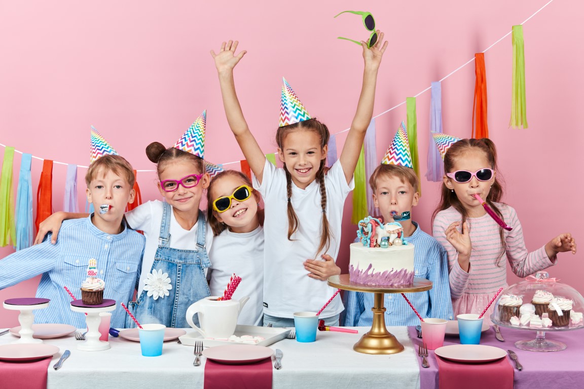 enfants déguisés qui posent avec le gâteau d'anniversaire